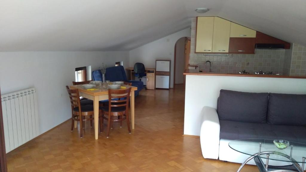 a living room with a table and a couch at Apartma Ivan in Portorož