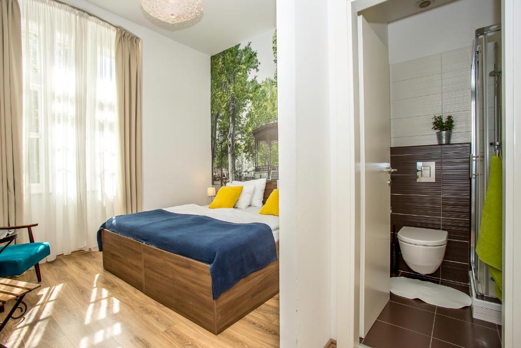 a small bedroom with a bed and a bathroom at 4citywindows in Zagreb
