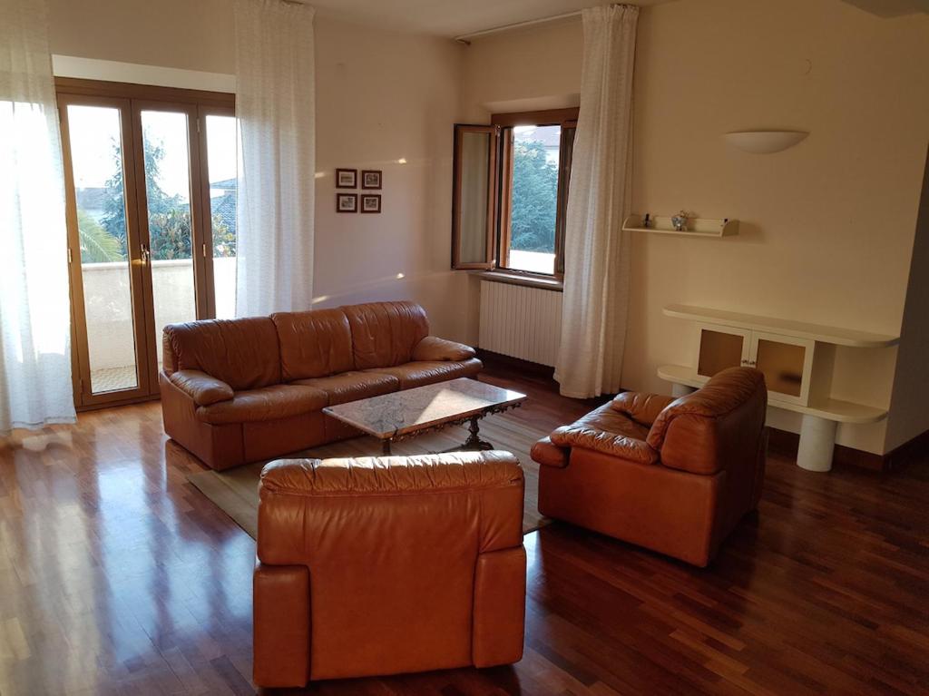 a living room with two couches and a table at K01 - Castelfidardo, meraviglioso quadrilocale con terrazzo in Castelfidardo