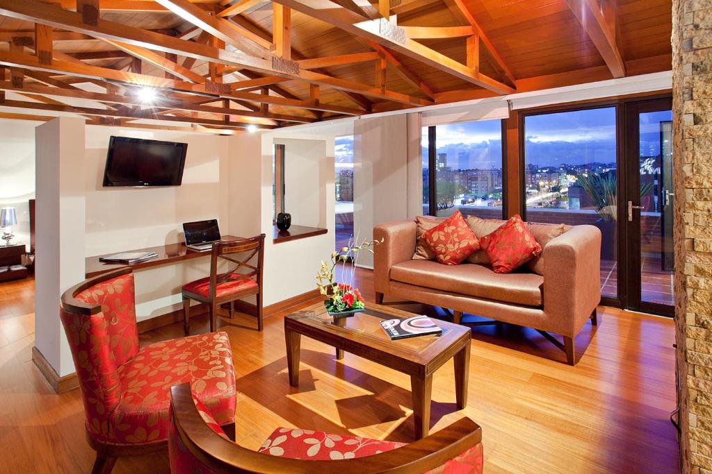 a living room with a couch and a table at Santafe Boutique Hotel in Bogotá