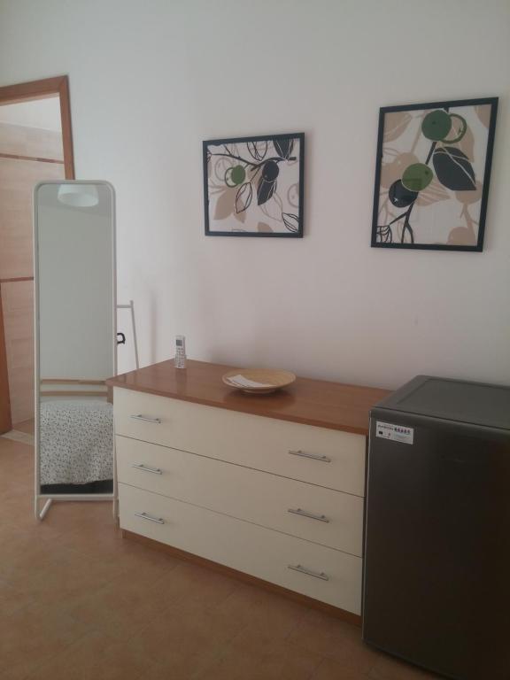 a room with a dresser and a mirror and a dresser at Akron B&B in SantʼAlessio Siculo