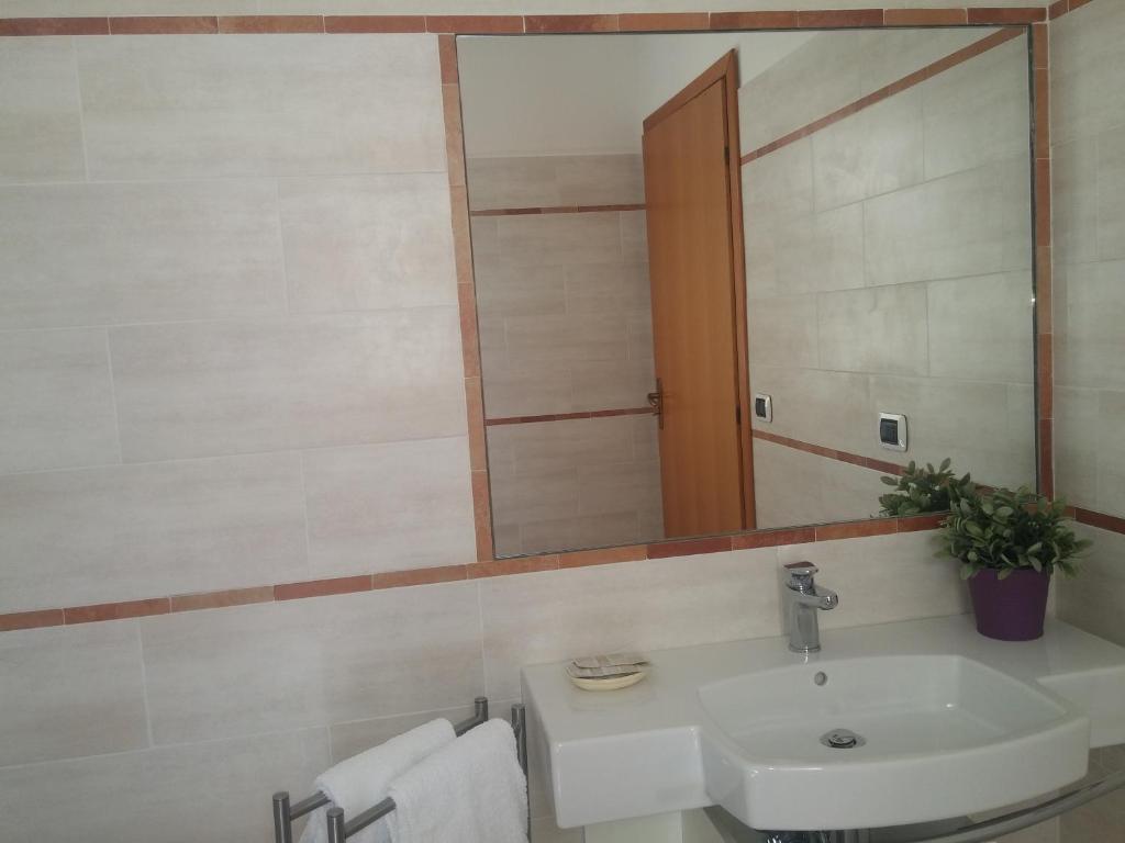 a bathroom with a sink and a mirror at Akron B&B in SantʼAlessio Siculo