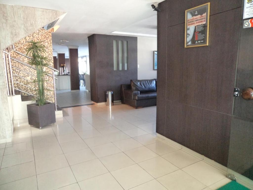 a lobby with a living room and a couch at Guarany Hotel Express in João Pessoa