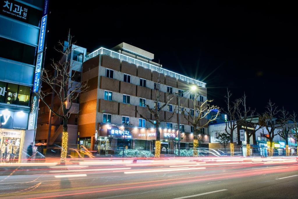 a building on a city street at night at Gangneung Donga Hotel in Gangneung