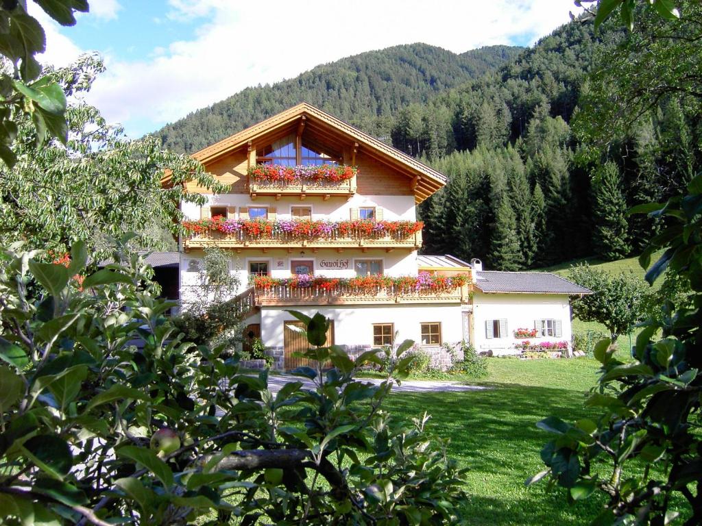 a building with flowers on the balconies of it at Ganoihof apartments in Funes