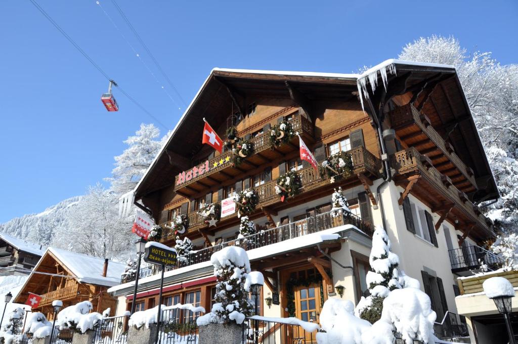a large building with snow on it in the mountains at Boutique Hotel Beau-Séjour & Spa Superior in Champéry
