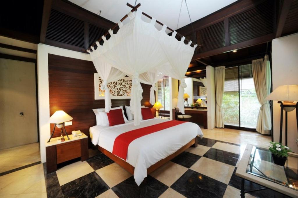 een slaapkamer met een groot bed met een baldakijn bij Finna Golf & Country Club in Prigen