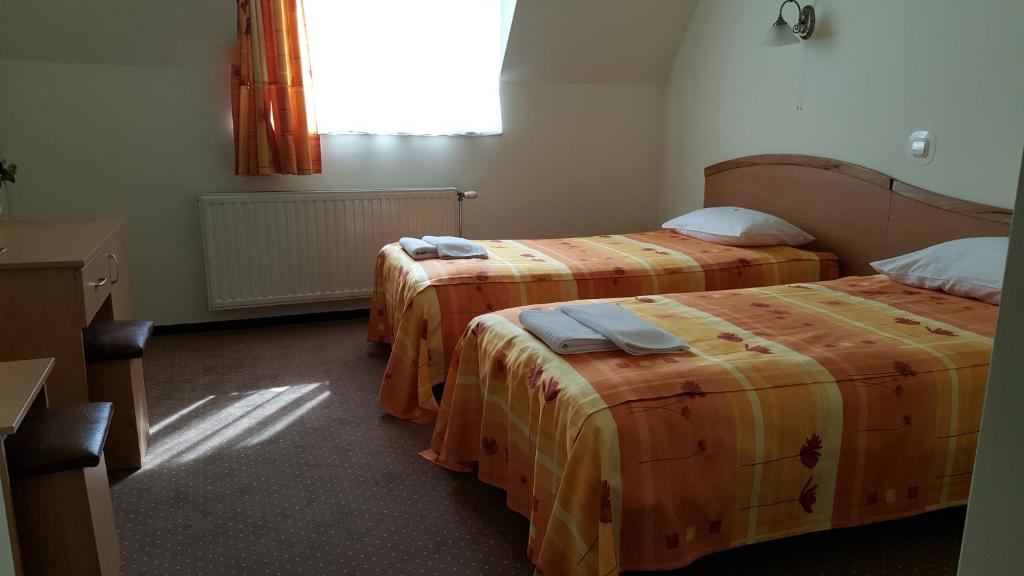 Postel nebo postele na pokoji v ubytování Hotel Melody