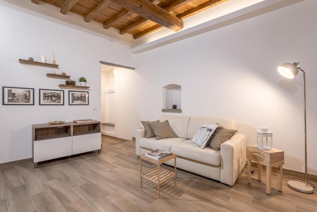 a living room with a couch and a table at Santa Croce Place by Mmega in Florence