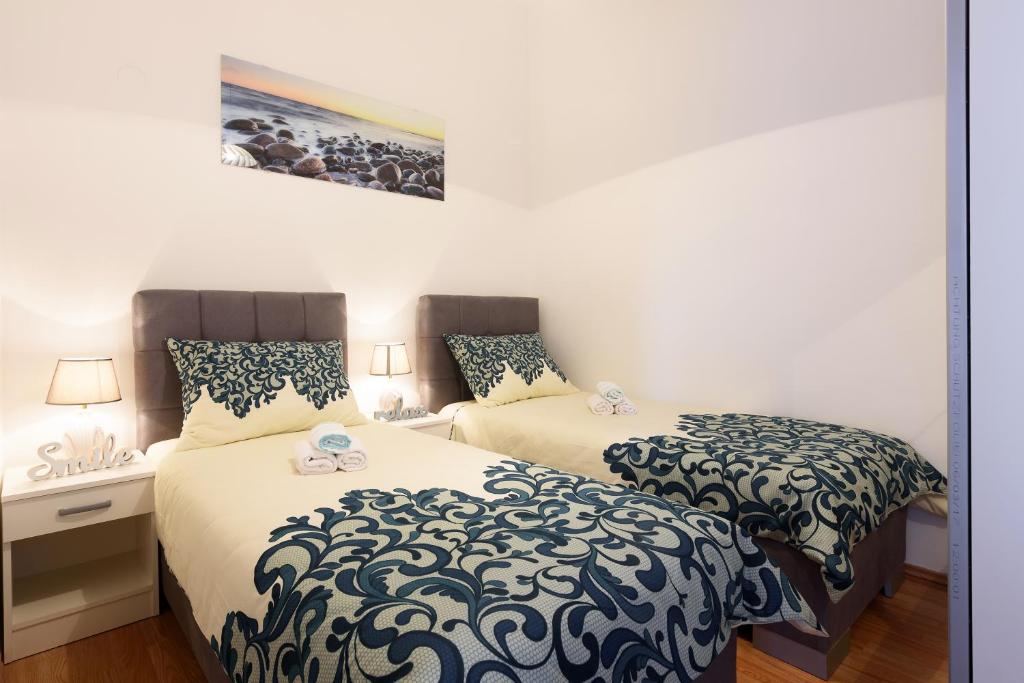 Posteľ alebo postele v izbe v ubytovaní Apartmani Judita