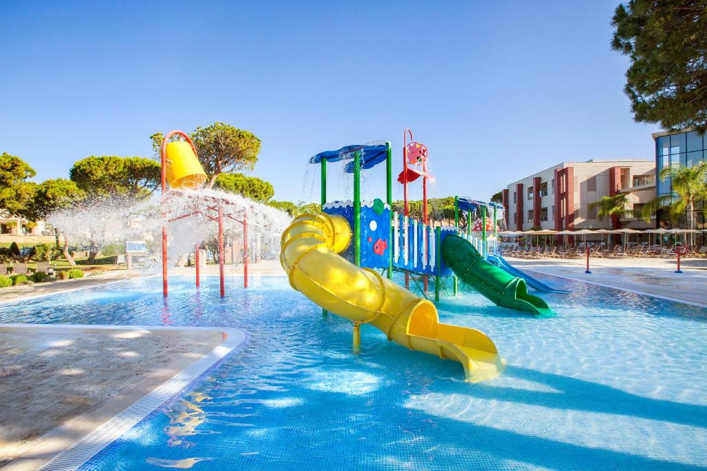a pool with a water park with slides and water pistols at Hipotels Barrosa Garden in Chiclana de la Frontera