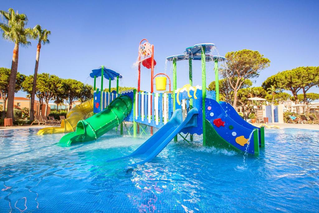 a water park with a water slide in a pool at Hipotels Barrosa Garden in Chiclana de la Frontera