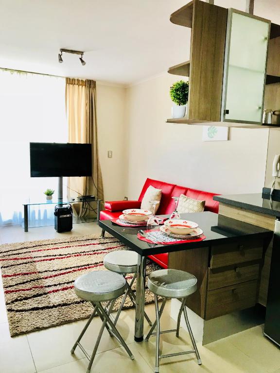 a living room with a table with two stools at Full Moneda 909 in Santiago