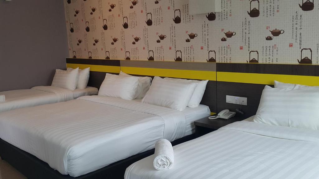 Voodi või voodid majutusasutuse Kampar Boutique Hotel toas
