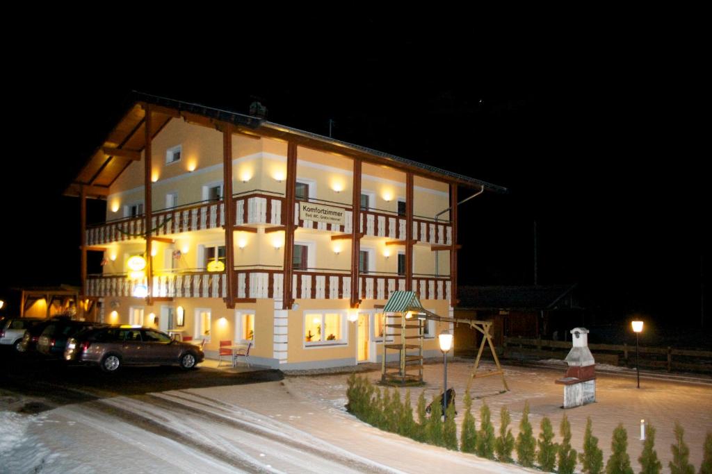 a large building with a car parked in front of it at Bed&Breakfast Schwaiger in Mörtschach