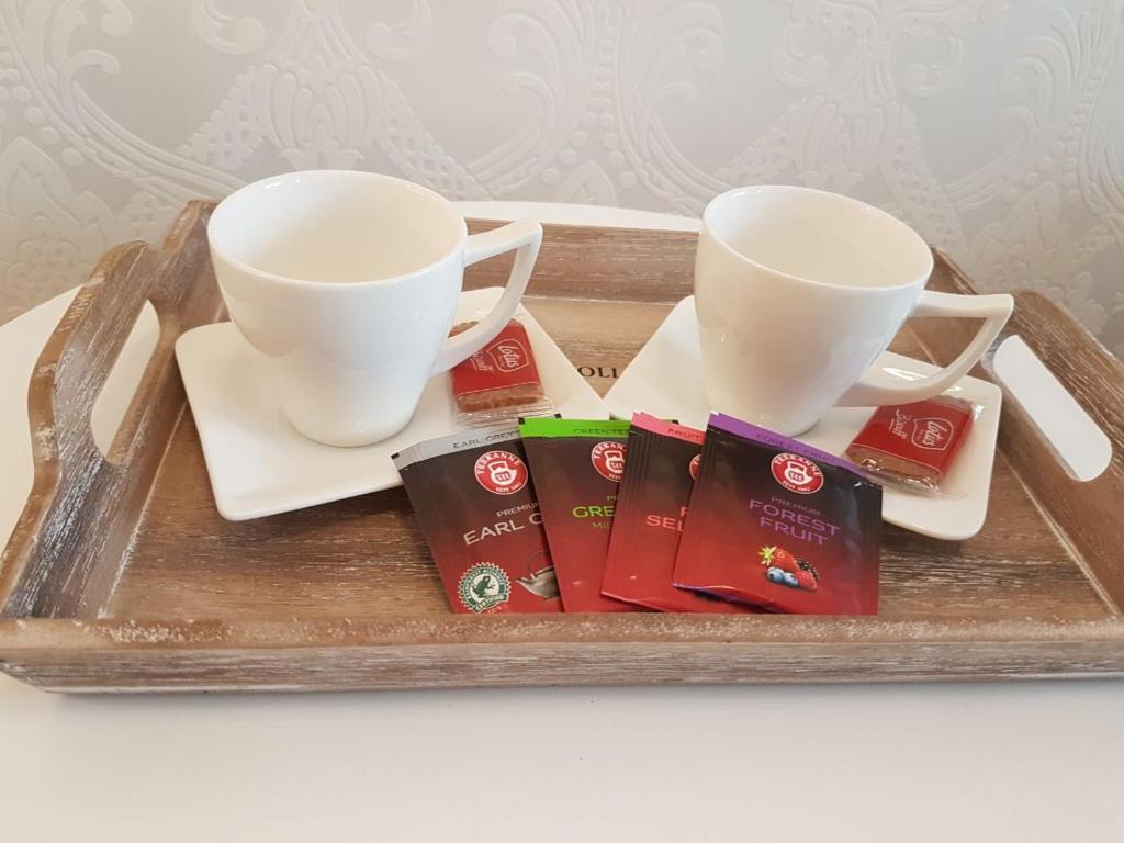 a tray with two cups and tea packets on it at Kraljev Park (King's Park) in Novi Sad