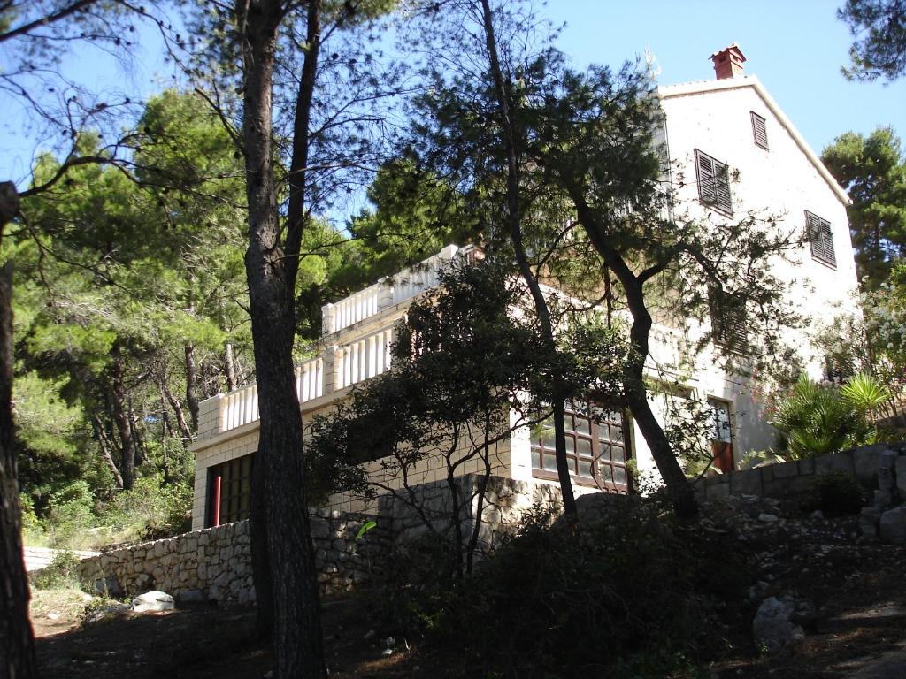 a large white building with trees in front of it at Ancila in Brna