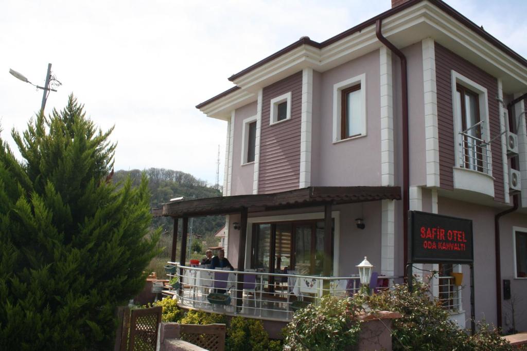 a building with people standing on a balcony at Sapphire Hotel in Ağva