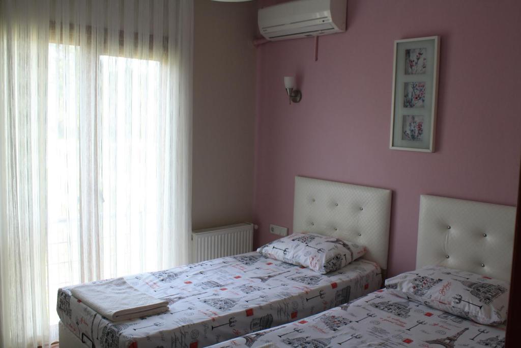 A bed or beds in a room at Sapphire Hotel