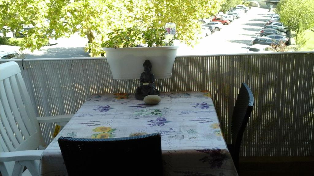 a teddy bear sitting at a table on a balcony at Villa Thermae in Gréoux-les-Bains