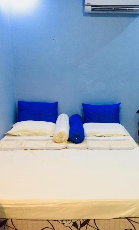 Postel nebo postele na pokoji v ubytování Mulia Homestay