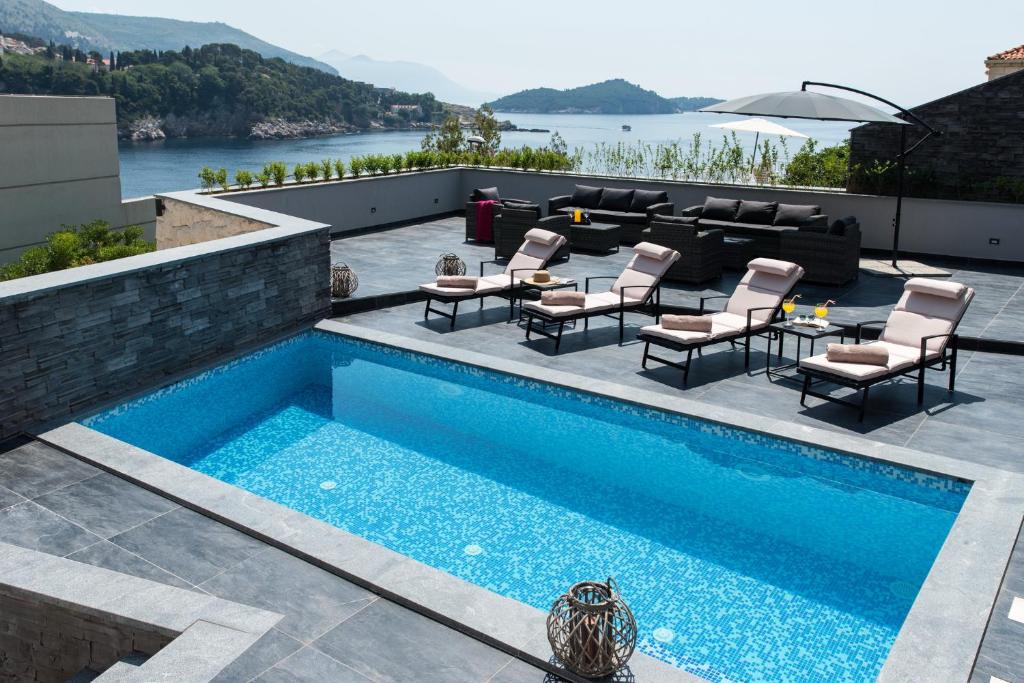 a swimming pool on the roof of a house at Villa Jolie in Dubrovnik