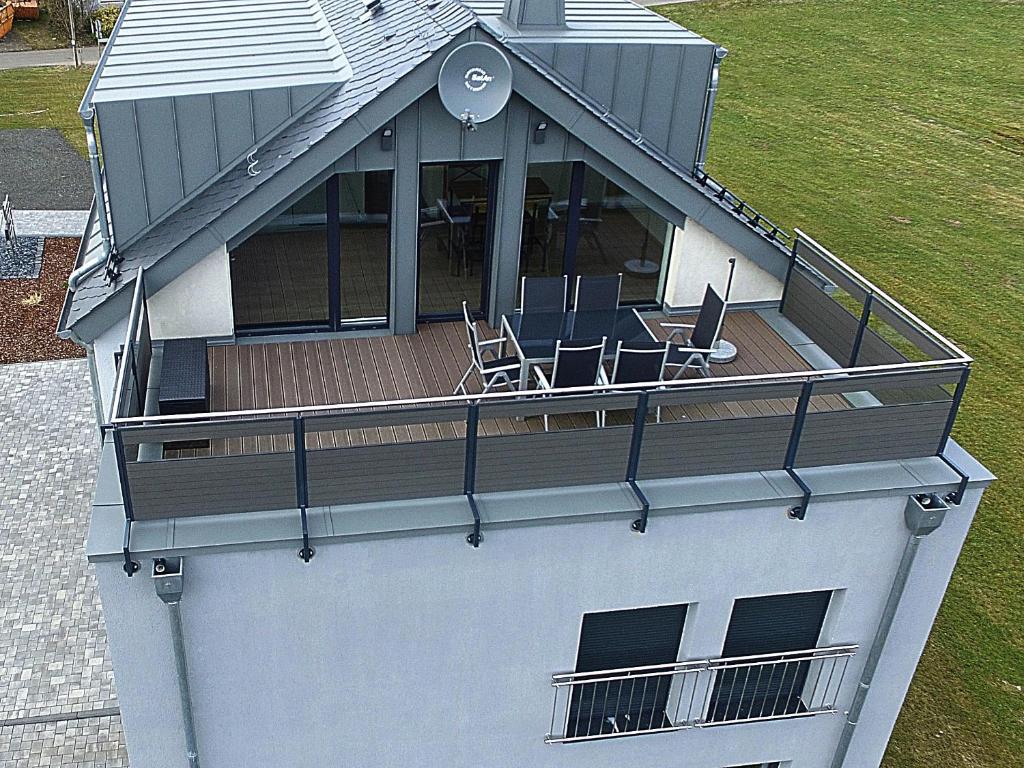 an aerial view of a house with chairs on a deck at Altes Haus in Sevenig