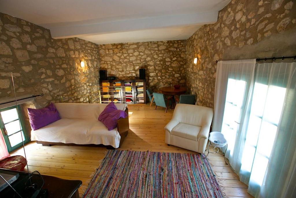 a living room with a couch and a chair at Abeona Mediterranean Villa in Drivenik