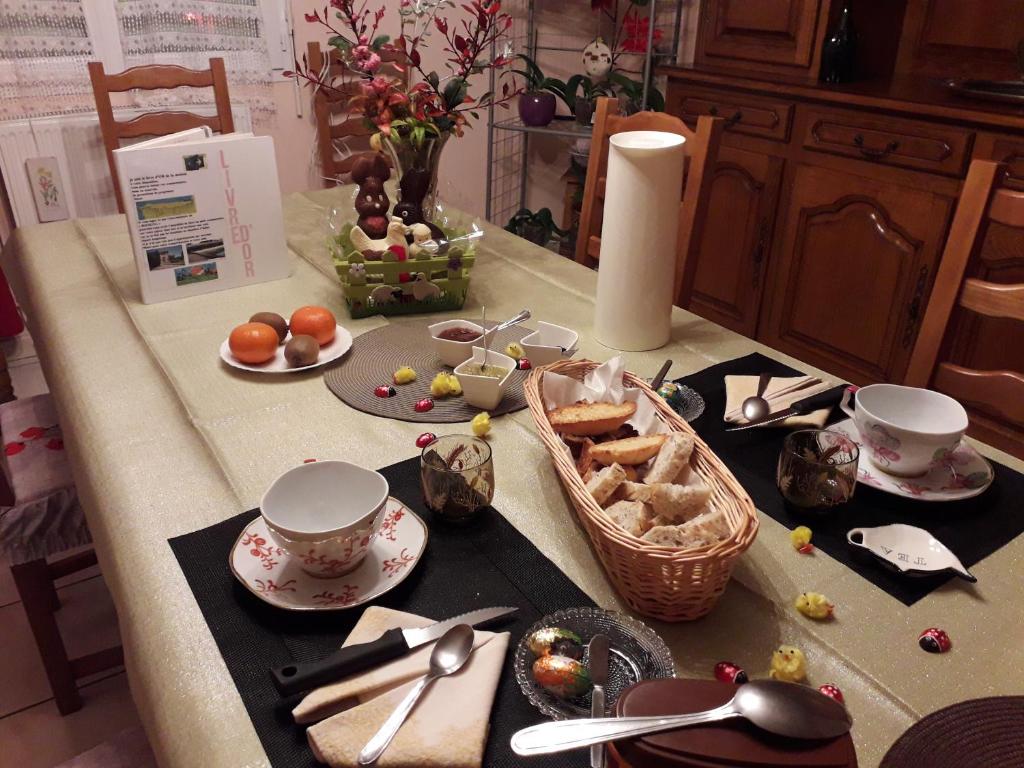 a kitchen counter with a table with food on it at La Nouste Maisoun in Barcelonne-du-Gers