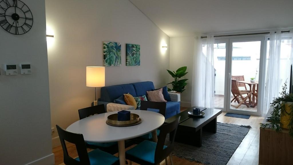 un soggiorno con tavolo e divano blu di Tauro 195 near El Corte Ingles a Lisbona