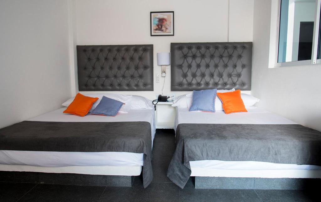 Postel nebo postele na pokoji v ubytování Hotel Grand H&R