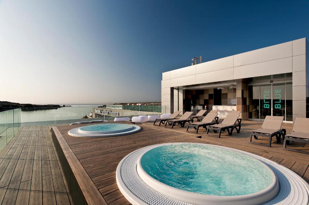 a hot tub on the deck of a building at Barceló Hamilton Menorca - Adults Only in Es Castell