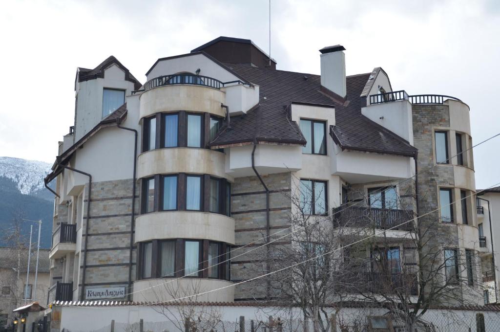 a large building with a roof on top of it at Guest House Laudis in Bansko