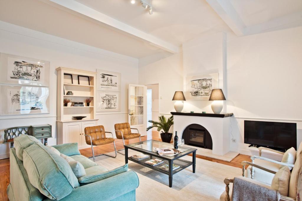 a living room filled with furniture and a fireplace at Estoril House, 18 in Estoril