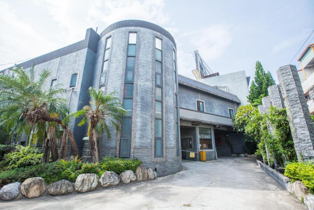 a building with palm trees in front of it at Water City Motel in Daya