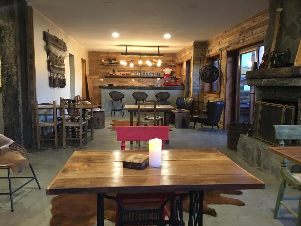 a dining room with a table and a fireplace at Hotel 381 Panguipulli in Panguipulli