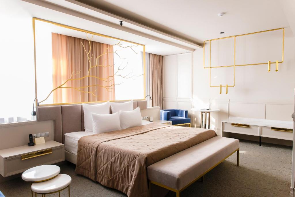a hotel room with a large bed and a window at Amur Hotel in Khabarovsk
