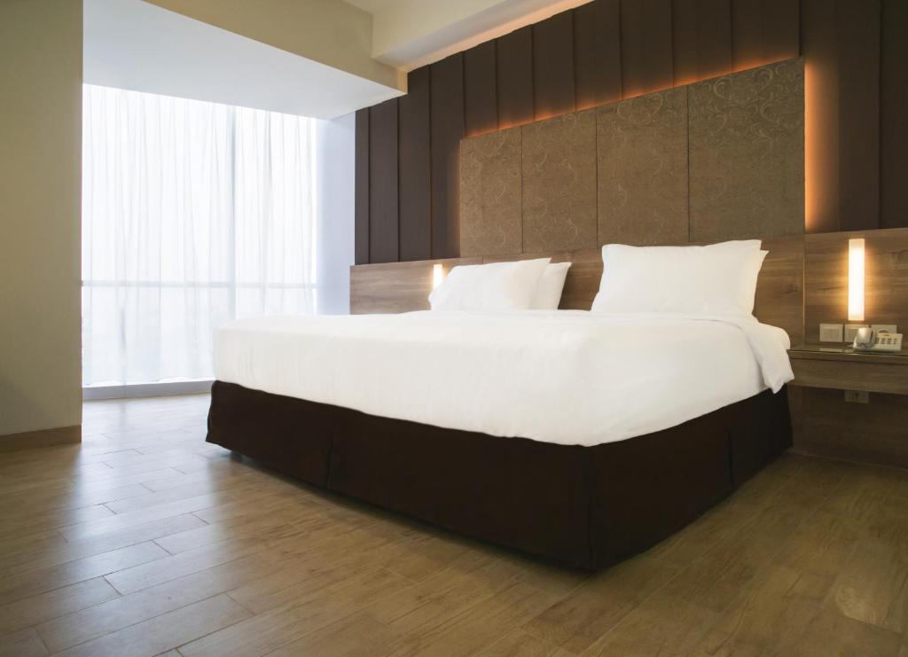 Postel nebo postele na pokoji v ubytování Grand G7 Hotel Kemayoran