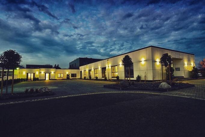 a large white building with lights on it at night at OK Das Businesshotel in Braunschweig