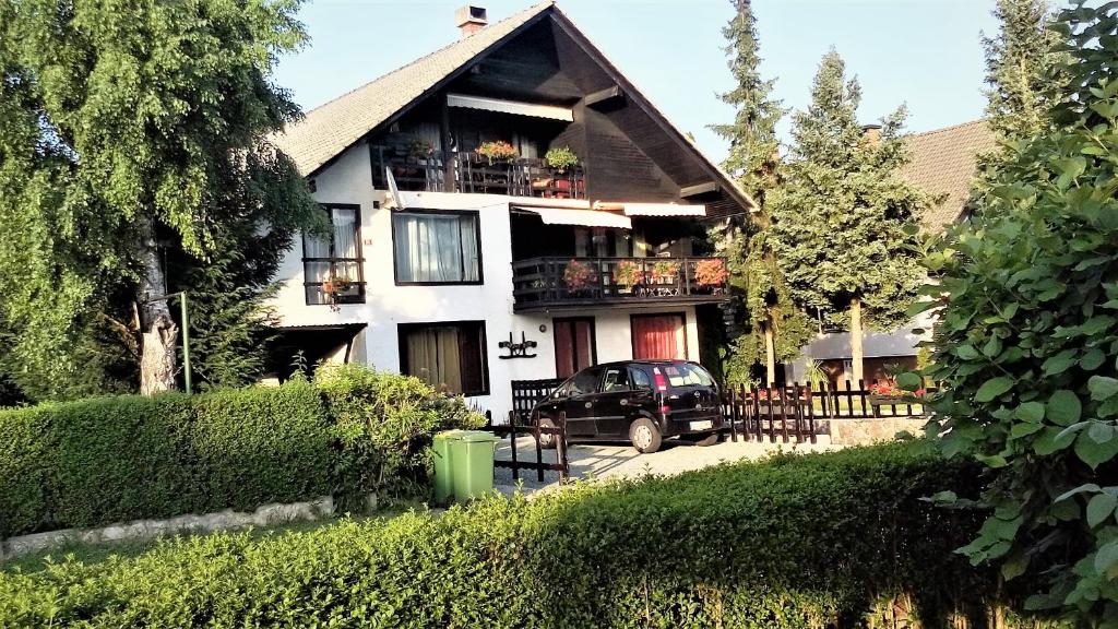 a house with a car parked in front of it at Aparthouse Ani in Radovljica