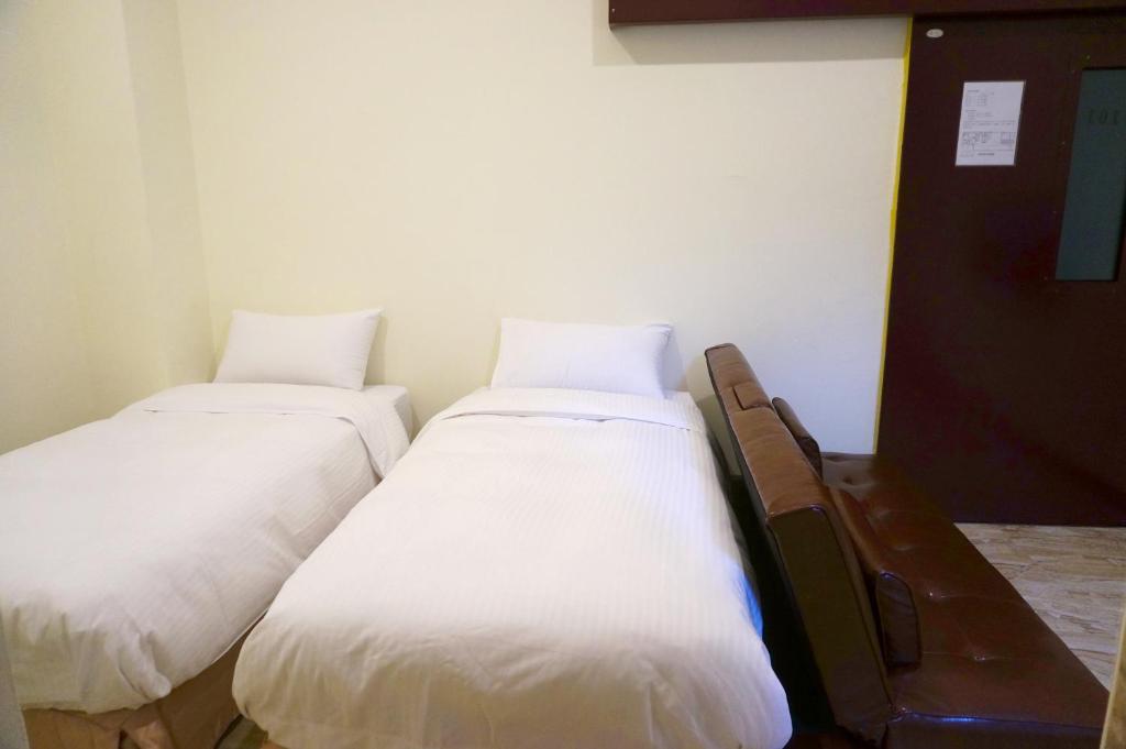 Postel nebo postele na pokoji v ubytování ChangJu Hotel-附免費停車位