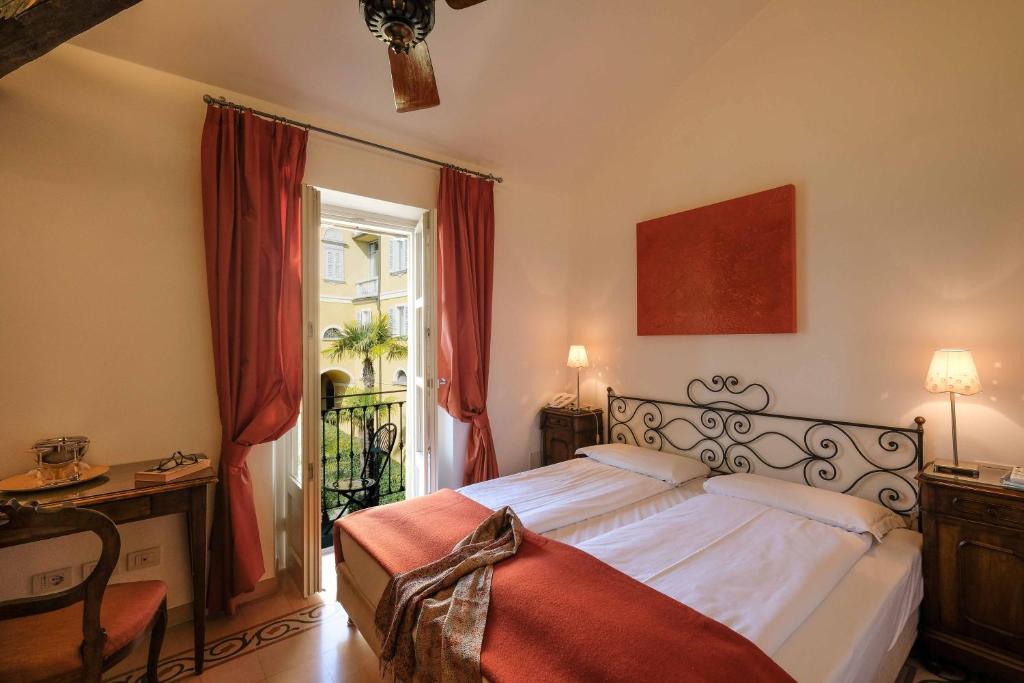 Posteľ alebo postele v izbe v ubytovaní Albergo Milano
