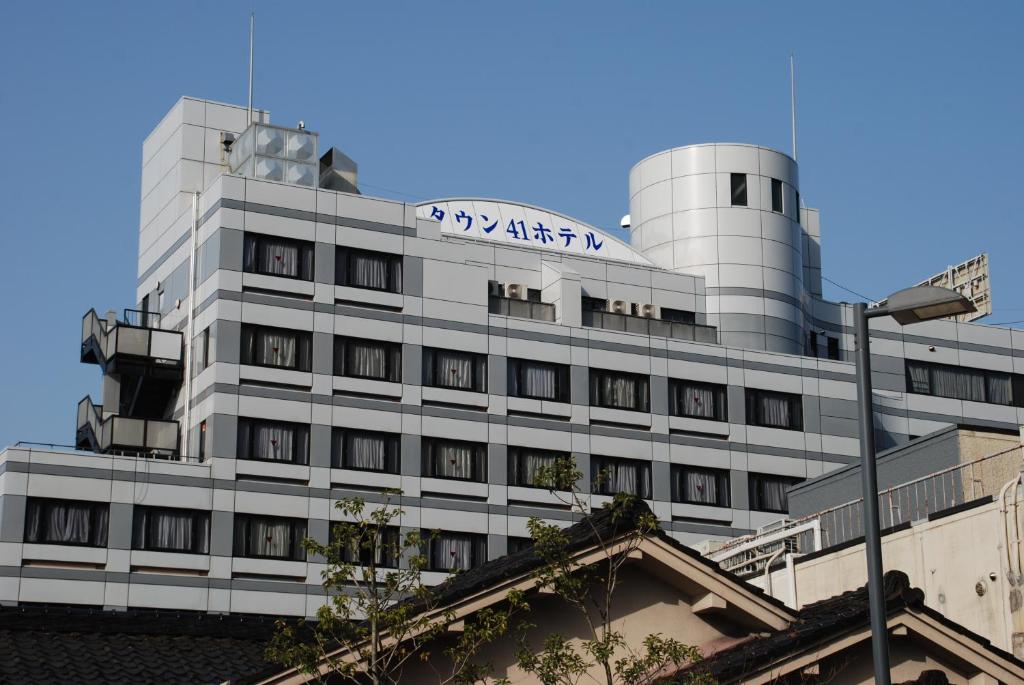 a building with a sign on top of it at Town Hotel 41 in Kanazawa