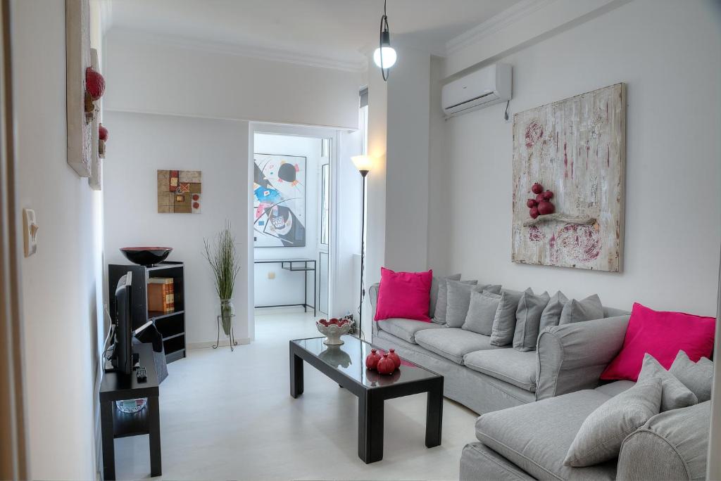 a living room with a couch and a table at Cosy apartment in Glyfada center in Athens