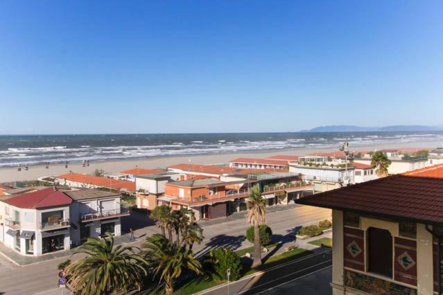 a view of a town with a beach and buildings at Bomboniera fronte mare ! in Viareggio