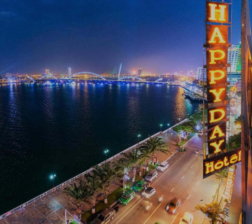 a view of a river and a city at night at Happy Day Hotel & Spa in Danang