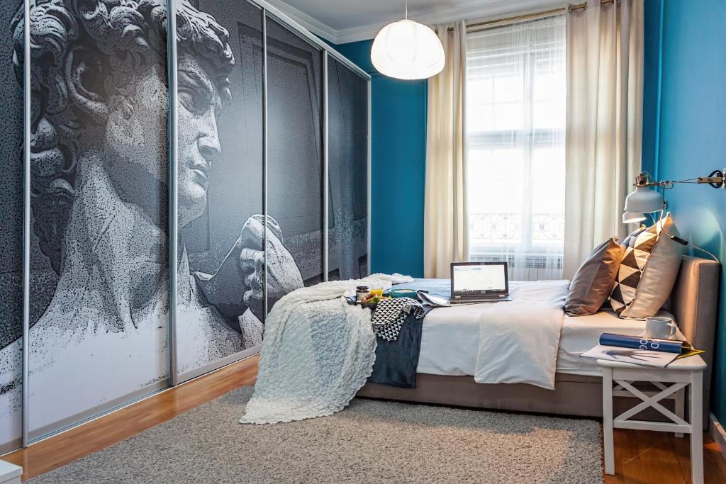a bedroom with a black and white picture of a woman at Designer Apartment Eclectica in Belgrade