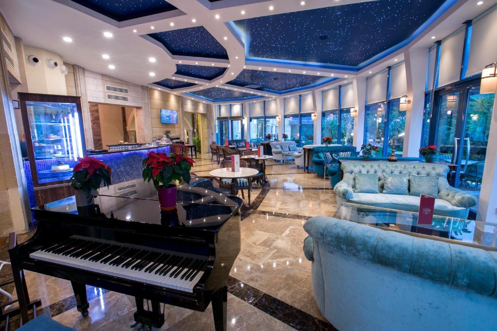 a lobby with a piano and couches and a bar at Merit Lefkosa Hotel & Casino in North Nicosia