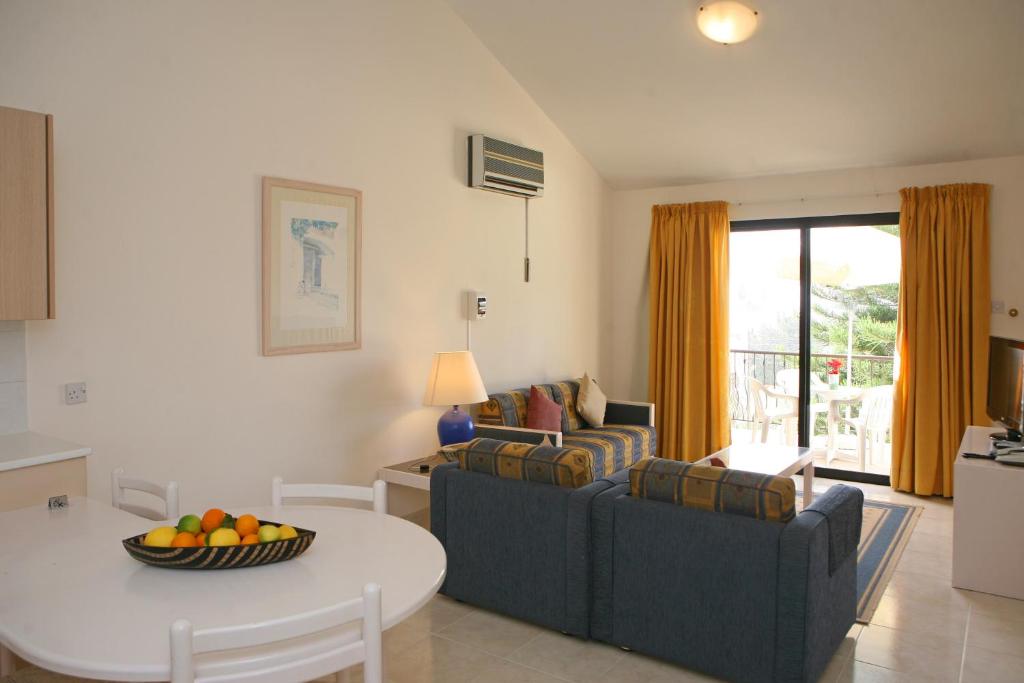 a living room with a couch and a table at Club Aphrodite in Erimi