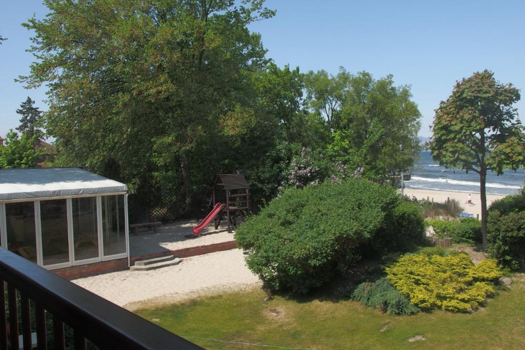 a view from a balcony of a yard with a playground at Patio Apartamenty i Pokoje in Niechorze